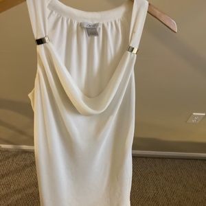 Cache ivory sleeveless top with silver grommets flowy fabric.